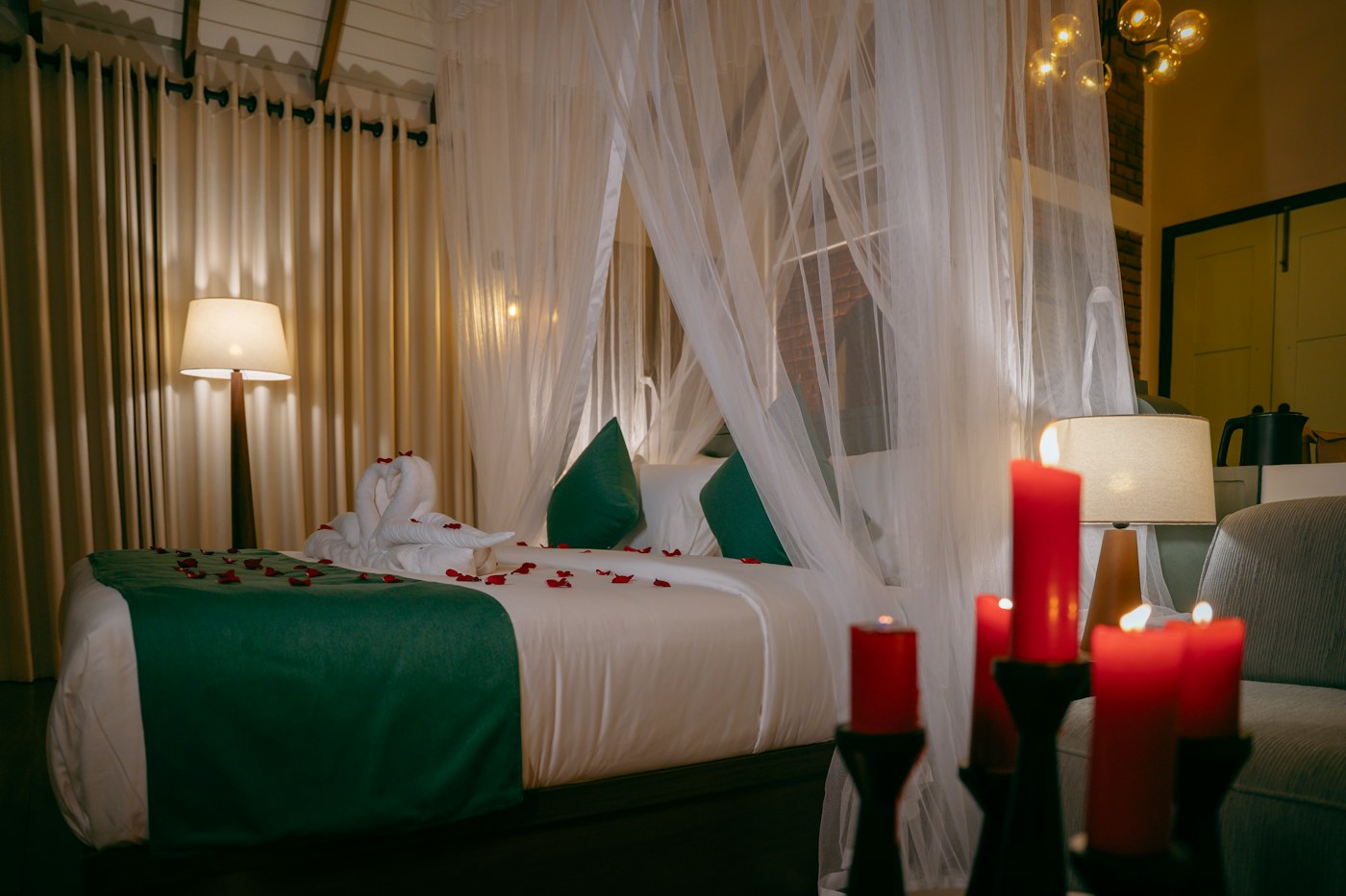 Canopy bed with candles in a hotel suite